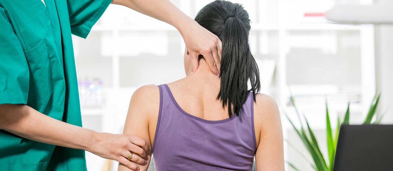 Patient with neck pain is examined by a doctor